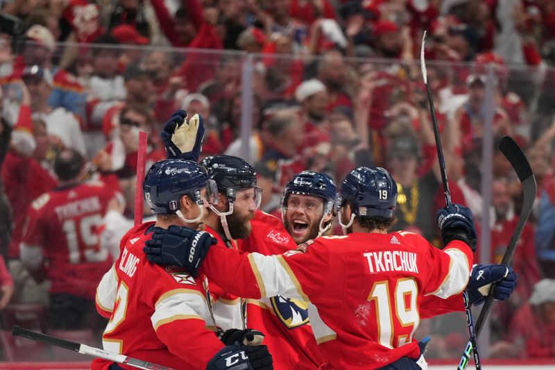 Jun 10, 2024; Sunrise, Florida, USA; Florida Panthers defenseman Aaron Ekblad (5) celebrates scoring an empty net goal with defenseman Gustav Forsling (42) and forward Matthew Tkachuk (19) during the third period against the Edmonton Oilers in game two of the 2024 Stanley Cup Final at Amerant Bank Arena. Mandatory Credit: Jim Rassol-USA TODAY Sports