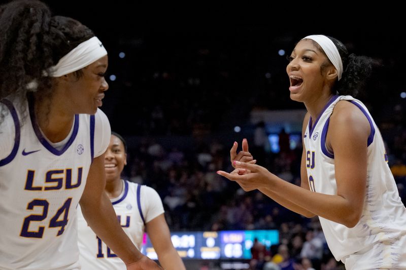 Nov 30, 2023; Baton Rouge, Louisiana, USA; LSU Lady Tigers forward Angel Reese, right, reacts after a score next to guard Aneesah Morrow (24) and guard Mikaylah Williams, center, during the second half against the Virginia Tech Hokies at Pete Maravich Assembly Center. Mandatory Credit: Matthew Hinton-USA TODAY Sports