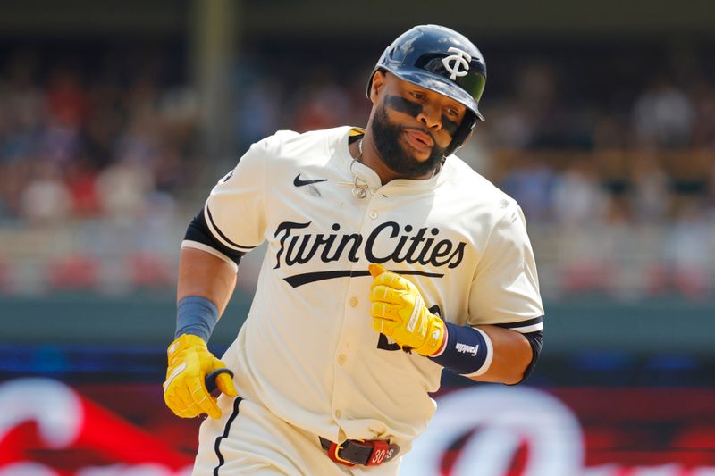 Aug 14, 2024; Minneapolis, Minnesota, USA; Minnesota Twins first baseman Carlos Santana (30) runs the bases after hitting a solo home run against the Kansas City Royals in the fourth inning at Target Field. Mandatory Credit: Bruce Kluckhohn-USA TODAY Sports