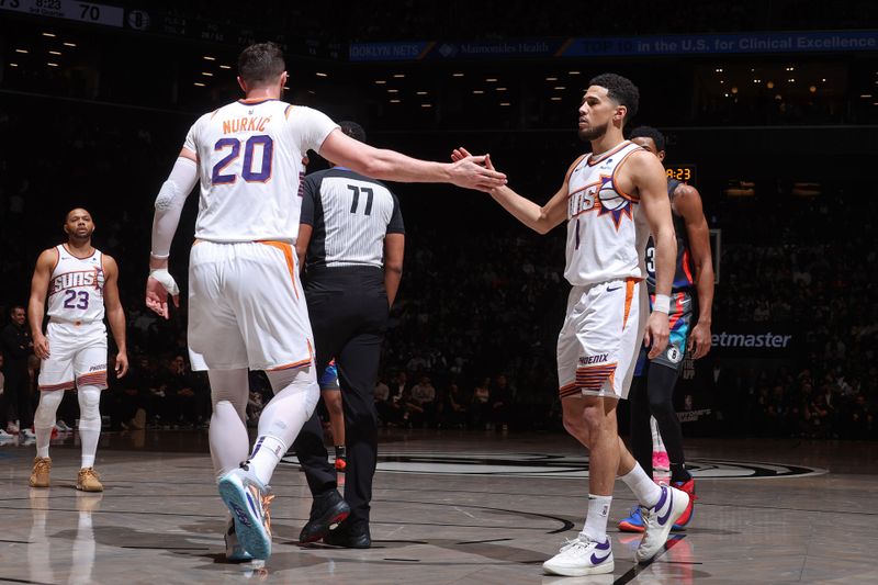 BROOKLYN, NY - JANUARY 31: Devin Booker #1 and Jusuf Nurkic #20 of the Phoenix Suns high five during the game against the Brooklyn Nets on January 31, 2024 at Barclays Center in Brooklyn, New York. NOTE TO USER: User expressly acknowledges and agrees that, by downloading and or using this Photograph, user is consenting to the terms and conditions of the Getty Images License Agreement. Mandatory Copyright Notice: Copyright 2024 NBAE (Photo by Nathaniel S. Butler/NBAE via Getty Images)