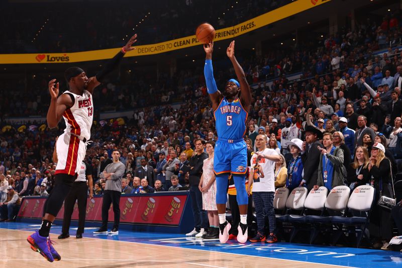 OKLAHOMA CITY, OK - MARCH 8:  Luguentz Dort #5 of the Oklahoma City Thunder shoots a three point basket during the game against the Miami Heat on March 8, 2024 at Paycom Arena in Oklahoma City, Oklahoma. NOTE TO USER: User expressly acknowledges and agrees that, by downloading and or using this photograph, User is consenting to the terms and conditions of the Getty Images License Agreement. Mandatory Copyright Notice: Copyright 2024 NBAE (Photo by Zach Beeker/NBAE via Getty Images)