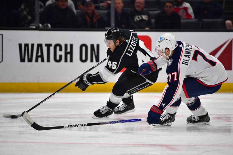 Mar 16, 2023; Los Angeles, California, USA; Los Angeles Kings center Blake Lizotte (46) moves the puck against Columbus Blue Jackets defenseman Nick Blankenburg (77) during the second period at Crypto.com Arena. Mandatory Credit: Gary A. Vasquez-USA TODAY Sports