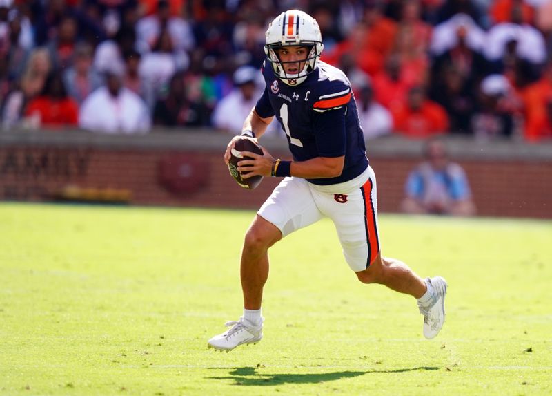 Sep 30, 2023; Auburn, Alabama, USA; Auburn Tigers quarterback Payton Thorne (1) scrambles out of the pocket against the Georgia Bulldogs during the first quarter at Jordan-Hare Stadium. Mandatory Credit: John David Mercer-USA TODAY Sports