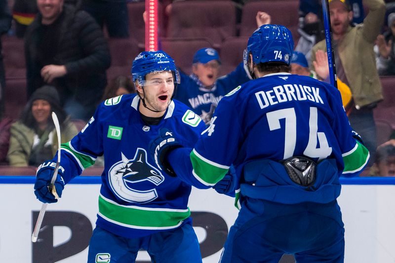 Nov 16, 2024; Vancouver, British Columbia, CAN; Vancouver Canucks defenseman Erik Brannstrom (26) and forward Jake DeBrusk (74) celebrate Brannstrom’s goal against the Chicago Blackhawks during the third period at Rogers Arena. Mandatory Credit: Bob Frid-Imagn Images