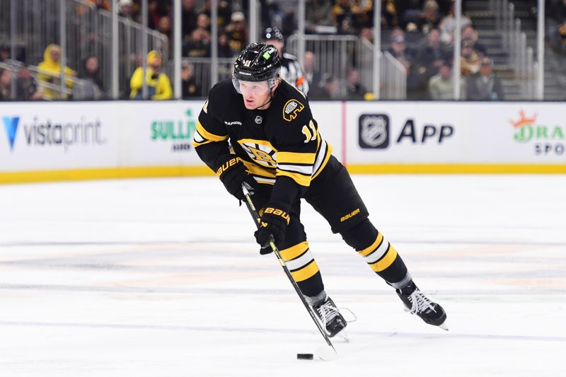 Oct 30, 2025; Boston, Massachusetts, USA; Boston Bruins center Casey Mittelstadt (11) skates with the puck during the first period against the Buffalo Sabres at TD Garden. Mandatory Credit: Bob DeChiara-Imagn Images