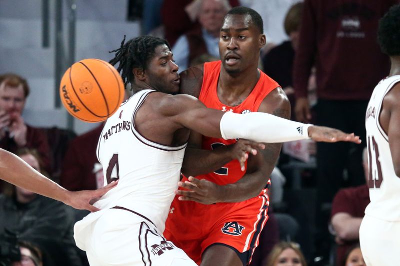 Jan 27, 2024; Starkville, Mississippi, USA; Auburn Tigers forward Jaylin Williams (2) passes the ball as Mississippi State Bulldogs forward Cameron Matthews (4) defends during the second half at Humphrey Coliseum. Mandatory Credit: Petre Thomas-USA TODAY Sports