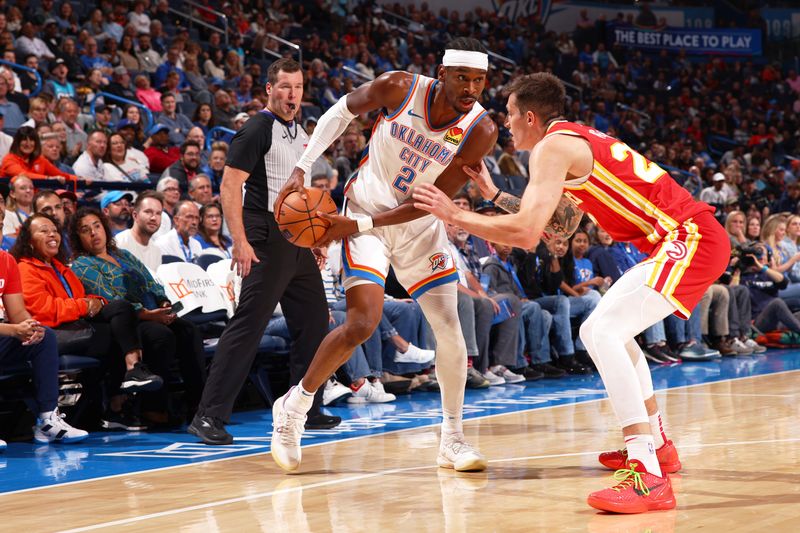 OKLAHOMA CITY, OK - OCTOBER 17: Shai Gilgeous-Alexander #2 of the Oklahoma City Thunder looks to pass the ball during the game against the Atlanta Hawks dribbles the ball during the game against the Atlanta Hawks on October 17, 2024 at Paycom Arena in Oklahoma City, Oklahoma. NOTE TO USER: User expressly acknowledges and agrees that, by downloading and or using this photograph, User is consenting to the terms and conditions of the Getty Images License Agreement. Mandatory Copyright Notice: Copyright 2024 NBAE (Photo by Zach Beeker/NBAE via Getty Images)