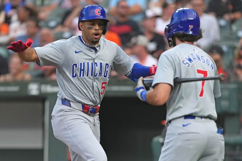 Jul 10, 2024; Baltimore, Maryland, USA; Chicago Cubs third baseman Christopher Morel (5) celebrates with shortstop Dansby Swanson (7) following his solo home run in the first inning against the Baltimore Orioles at Oriole Park at Camden Yards. Mandatory Credit: Mitch Stringer-USA TODAY Sports