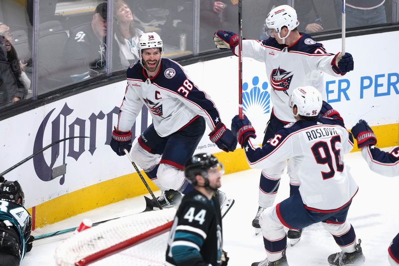 sFeb 17, 2024; San Jose, California, USA; Columbus Blue Jackets center Boone Jenner (38) celebrates with defenseman Damon Severson (top right) and center Jack Roslovic (96) after scoring a goal against the San Jose Sharks during the second period at SAP Center at San Jose. Mandatory Credit: Darren Yamashita-USA TODAY Sports