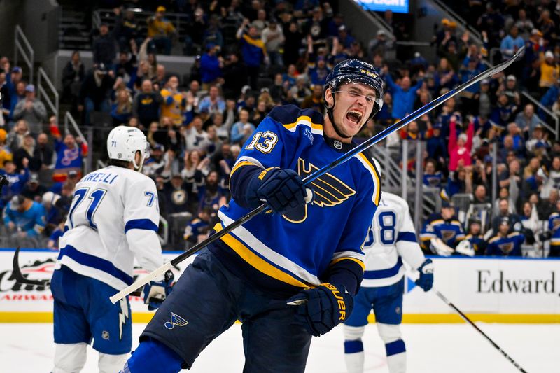 Nov 5, 2024; St. Louis, Missouri, USA;  St. Louis Blues right wing Alexey Toropchenko (13) reacts after scoring against the Tampa Bay Lightning during the second period at Enterprise Center. Mandatory Credit: Jeff Curry-Imagn Images