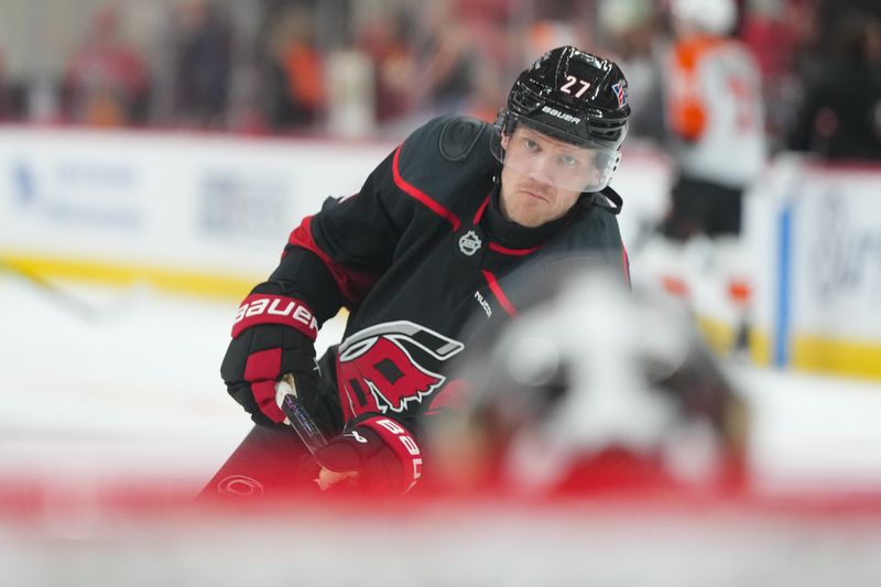 Oct 11, 2025; Raleigh, North Carolina, USA;  Carolina Hurricanes left wing Nikolaj Ehlers (27) takes a shot during the warmups before the game against the Philadelphia Flyers at Lenovo Center. Mandatory Credit: James Guillory-Imagn Images