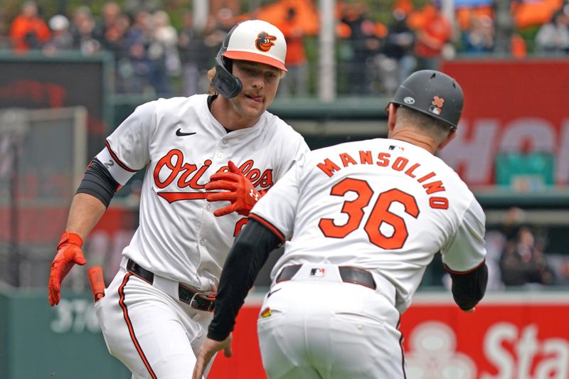 Apr 17, 2024; Baltimore, Maryland, USA; Baltimore Orioles shortstop Gunnar Henderson (2) greeted by coach Tony Mansolino (36) following his solo home run in the first inning against the Minnesota Twins at Oriole Park at Camden Yards. Mandatory Credit: Mitch Stringer-USA TODAY Sports