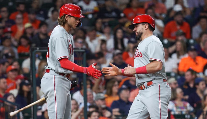 Apr 30, 2023; Houston, Texas, USA; Philadelphia Phillies left fielder Kyle Schwarber (12) celebrates with first baseman Alec Bohm (28) after scoring a runduring the eighth inning against the Houston Astros at Minute Maid Park. Mandatory Credit: Troy Taormina-USA TODAY Sports