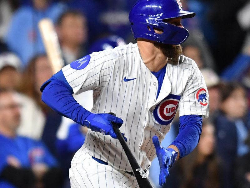 May 27, 2025; Chicago, Illinois, USA; Chicago Cubs first baseman Michael Busch (29) hits an RBI single during the eleventh inning against the Colorado Rockies at Wrigley Field. Mandatory Credit: Patrick Gorski-Imagn Images