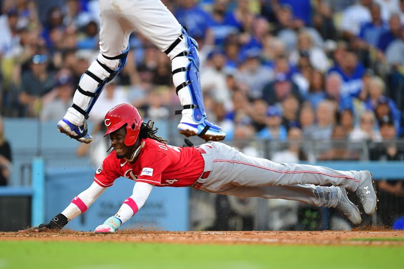 Jul 29, 2023; Los Angeles, California, USA; Cincinnati Reds shortstop Elly De La Cruz (44) slides under Los Angeles Dodgers catcher Will Smith (16) to score during the sixth inning at Dodger Stadium. Mandatory Credit: Gary A. Vasquez-USA TODAY Sports