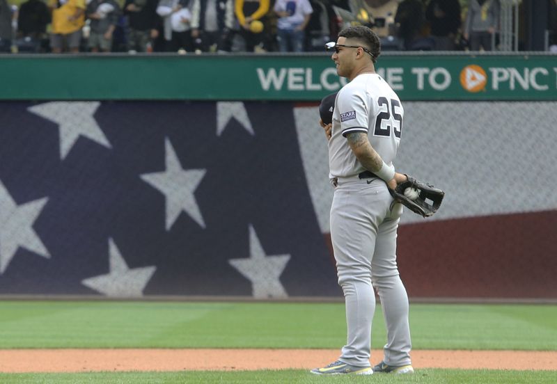 Sep 17, 2023; Pittsburgh, Pennsylvania, USA;  New York Yankees second baseman Gleyber Torres (25) stands for the playing of God Bless America against the Pittsburgh Pirates during the seventh inning stretch at PNC Park. Pittsburgh won 3-2. Mandatory Credit: Charles LeClaire-USA TODAY Sports