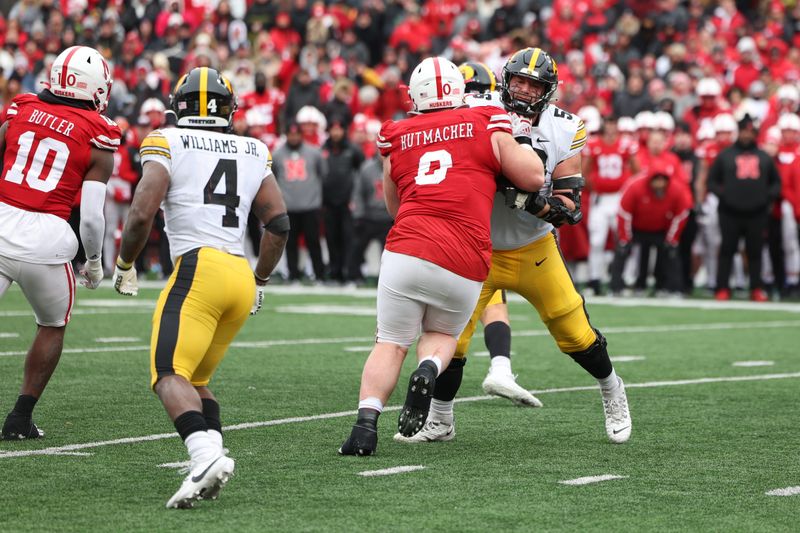 Nov 24, 2023; Lincoln, Nebraska, USA; Iowa Hawkeyes offensive lineman Nick DeJong (56) battles Nebraska Cornhuskers defensive lineman Nash Hutmacher (0) at Memorial Stadium. Mandatory Credit: Reese Strickland-USA TODAY Sports