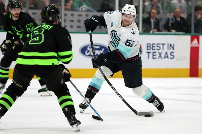 Apr 13, 2024; Dallas, Texas, USA; Seattle Kraken left wing Tye Kartye (52) shoots the puck against Dallas Stars defenseman Nils Lundkvist (5) in the first period at American Airlines Center. Mandatory Credit: Tim Heitman-USA TODAY Sports