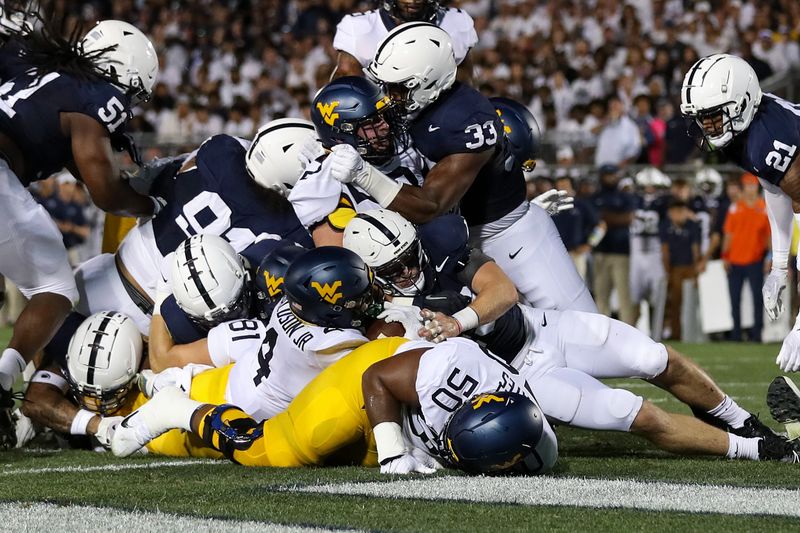 Sep 2, 2023; University Park, Pennsylvania, USA; West Virginia Mountaineers running back CJ Donaldson Jr. (4) scores a touchdown during the second quarter against the Penn State Nittany Lions at Beaver Stadium. Penn State defeated West Virginia 38-15. Mandatory Credit: Matthew O'Haren-USA TODAY Sports