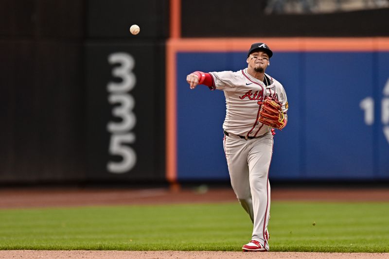 May 11, 2024; New York City, New York, USA; Atlanta Braves shortstop Orlando Arcia (11) fields a ground ball and throws to first base for an out against the New York Mets during the ninth inning at Citi Field. Mandatory Credit: John Jones-USA TODAY Sports