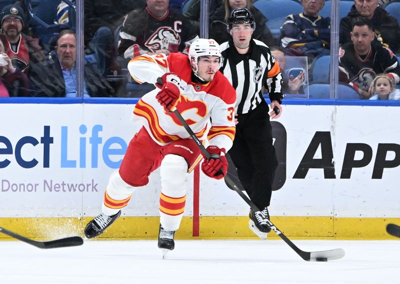 Nov 19, 2025; Buffalo, New York, USA; Calgary Flames defenseman Yan Kuznetsov (37) passes the puck in the first period against the Buffalo Sabres at KeyBank Center. Mandatory Credit: Mark Konezny-Imagn Images