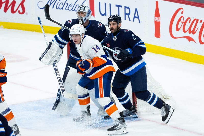 Jan 16, 2024; Winnipeg, Manitoba, CAN; Winnipeg Jets defenseman Dylan DeMelo (2) competes for position with New York Islanders forward Bo Horvat (14) in front of Winnipeg Jets goalie Connor Hellebuyck (37) during the third period at Canada Life Centre. Mandatory Credit: Terrence Lee-USA TODAY Sports