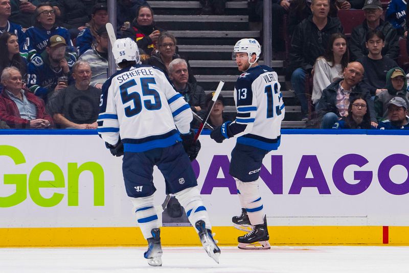 Feb 17, 2024; Vancouver, British Columbia, CAN; Winnipeg Jets forward Mark Scheifele (55) and forward Gabriel Vilardi (13) celebrate Vilardi   s goal against the Vancouver Canucks in the second period at Rogers Arena. Mandatory Credit: Bob Frid-USA TODAY Sports