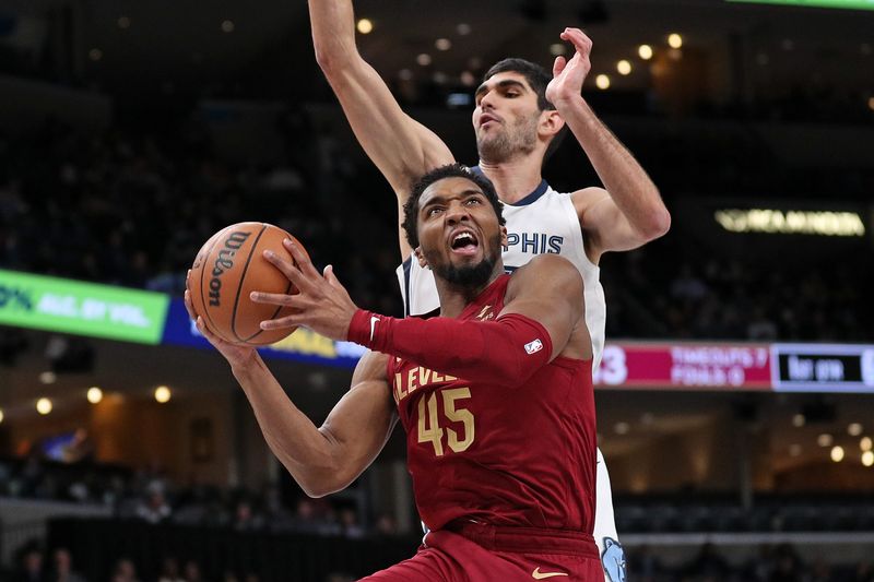 MEMPHIS, TENNESSEE - FEBRUARY 01: Donovan Mitchell #45 of the Cleveland Cavaliers goes to the basket against Santi Aldama #7 of the Memphis Grizzlies during the first half at FedExForum on February 01, 2024 in Memphis, Tennessee. (Photo by Justin Ford/Getty Images)