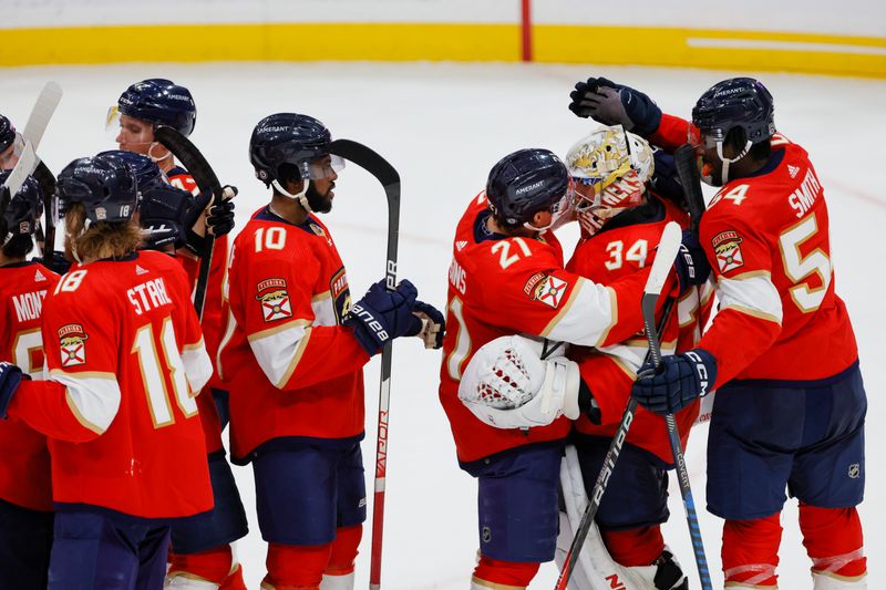 Apr 4, 2023; Sunrise, Florida, USA; Florida Panthers center Nick Cousins (21) and right wing Givani Smith (54) celebrates with goaltender Alex Lyon (34) after winning the game against the Buffalo Sabres at FLA Live Arena. Mandatory Credit: Sam Navarro-USA TODAY Sports