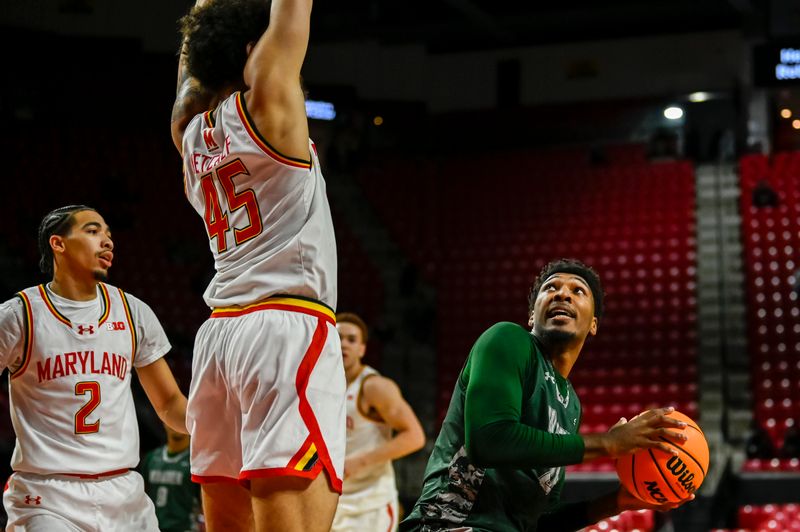 Dec 2, 2025; College Park, Maryland, USA;  aWagner Seahawks forward Sam Smith (24) looks to shoot as Maryland Terrapins center Collin Metcalf (45) defends during the first half at Xfinity Center. Mandatory Credit: Tommy Gilligan-Imagn Images