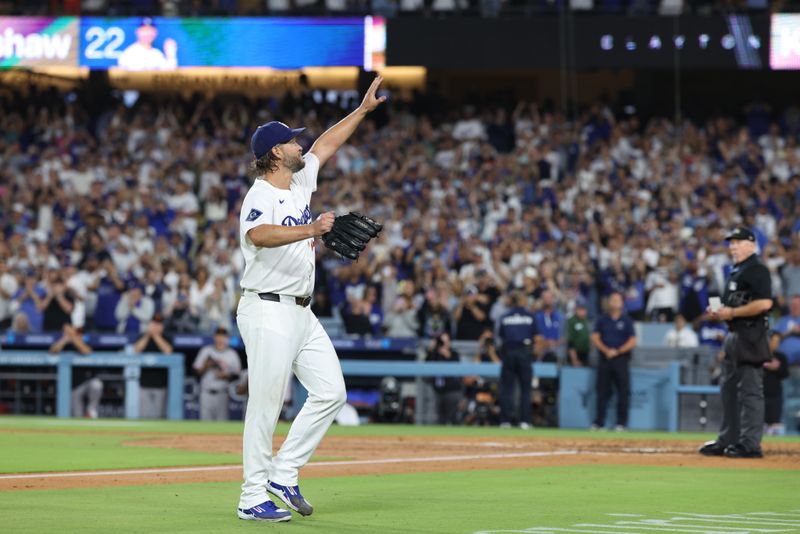 Sep 19, 2025; Los Angeles, California, USA; Los Angeles Dodgers pitcher Clayton Kershaw (22) salutes the crowd after being relieved during the fifth inning against the San Francisco Giants at Dodger Stadium. Mandatory Credit: Kiyoshi Mio-Imagn Images