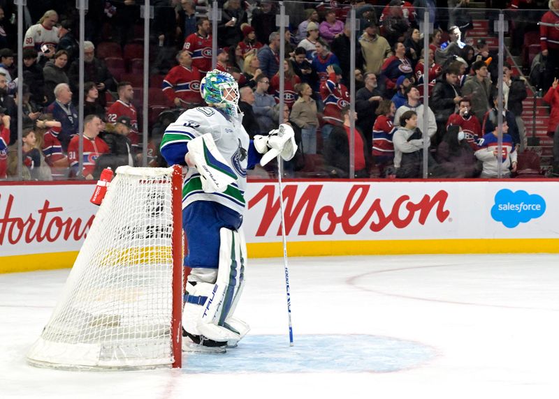 Jan 6, 2025; Montreal, Quebec, CAN; Vancouver Canucks goalie Kevin Lankinen (32) refuses to leave his net after the winning goal by Montreal Canadiens forward Nick Suzuki (not pictured) during the overtime period at the Bell Centre. Mandatory Credit: Eric Bolte-Imagn Images