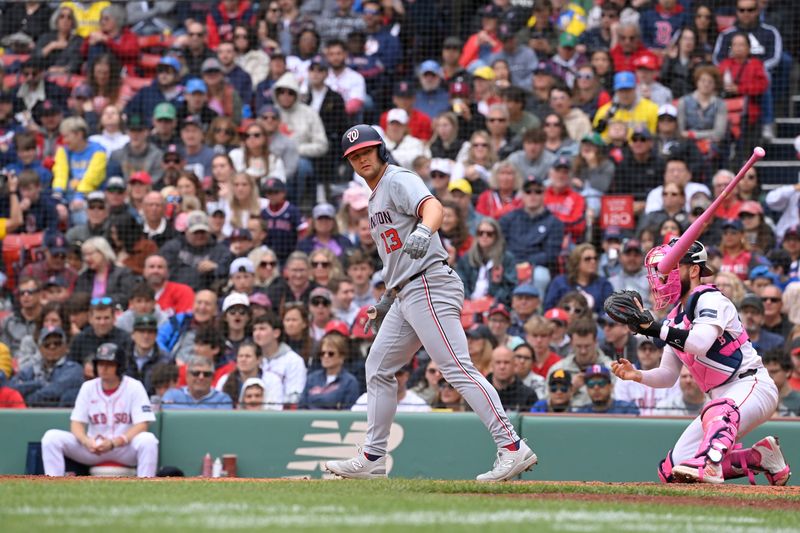 May 12, 2024; Boston, Massachusetts, USA;  Washington Nationals designated hitter Nick Senzel (13) is walked during the seventh inning against the Boston Red Sox at Fenway Park. Mandatory Credit: Eric Canha-USA TODAY Sports