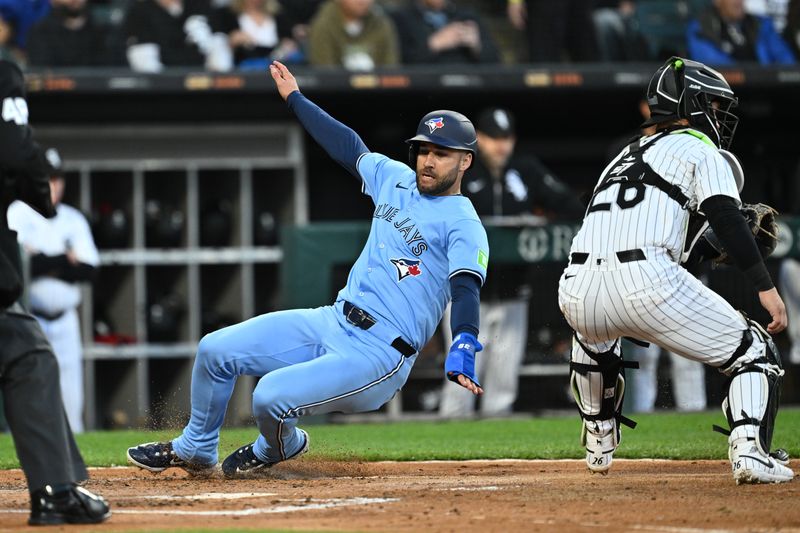 May 28, 2024; Chicago, Illinois, USA;  Toronto Blue Jays outfielder Kevin Kiermaier (39) slides home for a run in the second inning against the Chicago White Sox at Guaranteed Rate Field. Mandatory Credit: Jamie Sabau-USA TODAY Sports