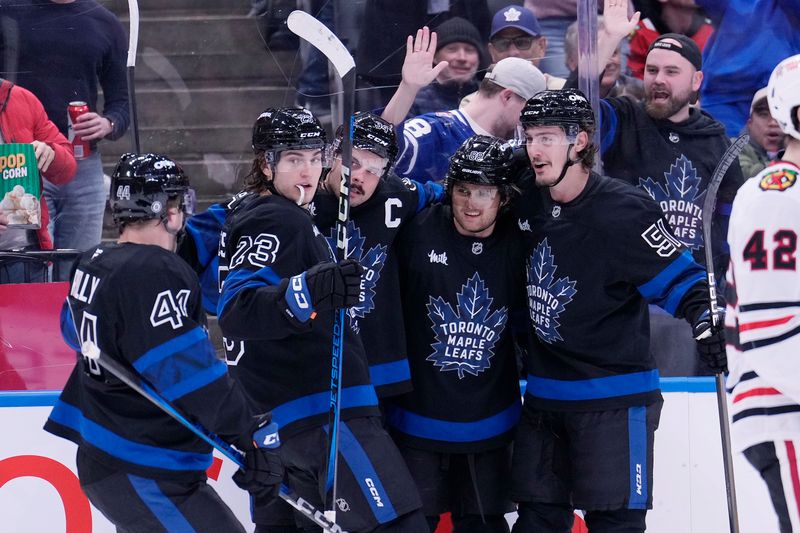 Dec 2, 2024; Toronto, Ontario, CAN; Toronto Maple Leafs forward Matthew Knies (23), defenseman Morgan Rielly (44), forward William Nylander (88), and defenseman Philippe Myers (51) celebrate a goal by forward Auston Matthews (34) against the Chicago Blackhawks during the first period at Scotiabank Arena. Mandatory Credit: John E. Sokolowski-Imagn Images