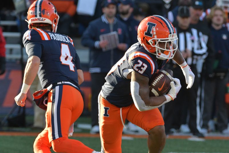 Nov 25, 2023; Champaign, Illinois, USA; Illinois Fighting Illini running back Reggie Love III (23) takes the handoff from quarterback John Paddock (4) during the first half at Memorial Stadium. Mandatory Credit: Ron Johnson-USA TODAY Sports