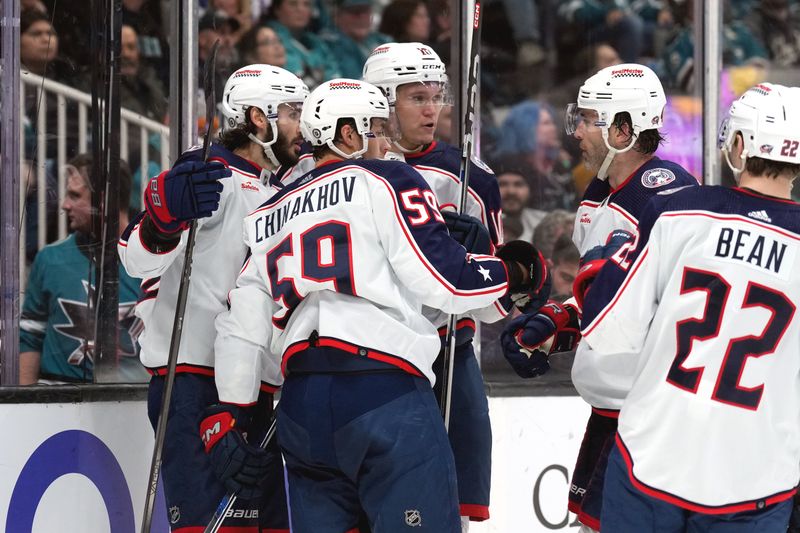 Feb 17, 2024; San Jose, California, USA; Columbus Blue Jackets right wing Kirill Marchenko (left) celebrates with teammates after scoring a goal against the San Jose Sharks during the first period at SAP Center at San Jose. Mandatory Credit: Darren Yamashita-USA TODAY Sports