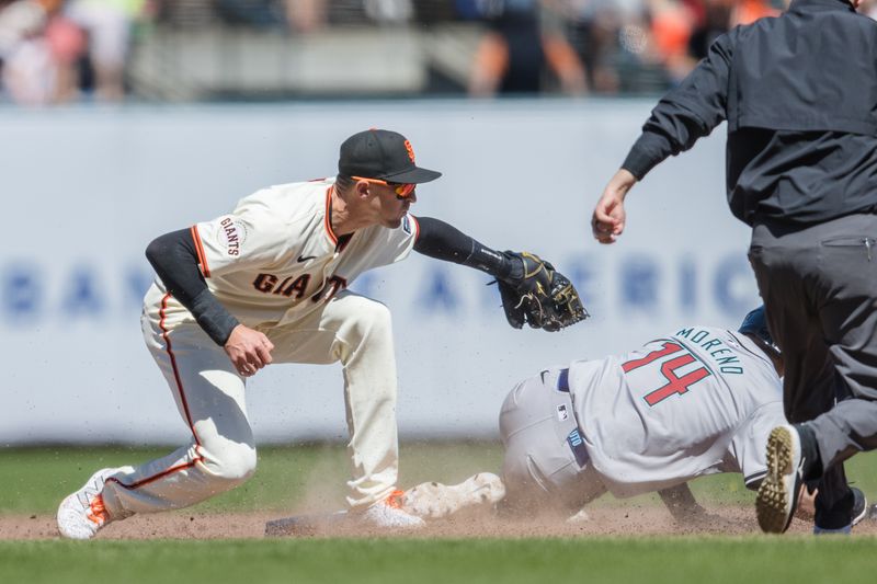 Apr 21, 2024; San Francisco, California, USA;  San Francisco Giants starting pitcher Jordan Hicks (12) tags Arizona Diamondbacks catcher Gabriel Moreno (14) after a failed steal attempt during the sixth inning at Oracle Park. Mandatory Credit: John Hefti-USA TODAY Sports