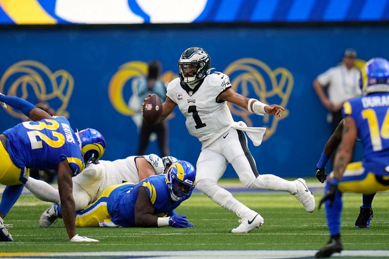 Philadelphia Eagles quarterback Jalen Hurts scrambles with the ball during the first half of an NFL football game against the Los Angeles Rams Sunday, Oct. 8, 2023, in Inglewood, Calif. (AP Photo/Gregory Bull)