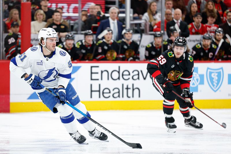 Jan 23, 2026; Chicago, Illinois, USA; Tampa Bay Lightning defenseman Charle-Edouard D'Astous (51) looks to pass the puck against the Chicago Blackhawks during the first period at United Center. Mandatory Credit: Kamil Krzaczynski-Imagn Images