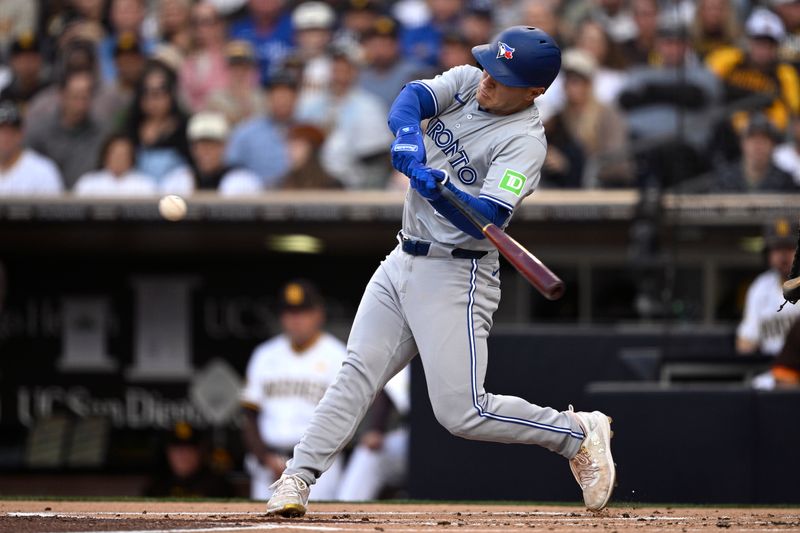 Apr 20, 2024; San Diego, California, USA; Toronto Blue Jays left fielder Daulton Varsho (25) hits a three-run home run against the San Diego Padres during the first inning at Petco Park. Mandatory Credit: Orlando Ramirez-USA TODAY Sports