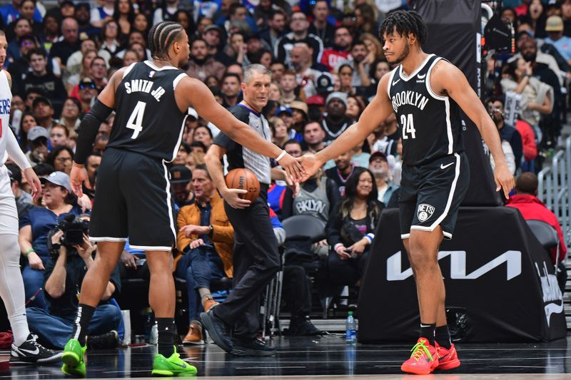 LOS ANGELES, CA - JANUARY 21: Cam Thomas #24 and Dennis Smith Jr. #4 of the Brooklyn Nets high five during the game against the LA Clippers on January 21, 2024 at Crypto.Com Arena in Los Angeles, California. NOTE TO USER: User expressly acknowledges and agrees that, by downloading and/or using this Photograph, user is consenting to the terms and conditions of the Getty Images License Agreement. Mandatory Copyright Notice: Copyright 2024 NBAE (Photo by Adam Pantozzi/NBAE via Getty Images)