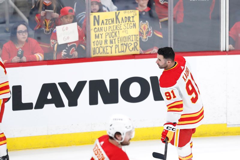 Apr 4, 2024; Winnipeg, Manitoba, CAN; Calgary Flames center Nazem Kadri (91) skates past fans before a game against the Winnipeg Jets at Canada Life Centre. Mandatory Credit: James Carey Lauder-USA TODAY Sports