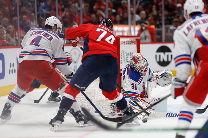 Apr 26, 2024; Washington, District of Columbia, USA; New York Rangers goaltender Igor Shesterkin (31) makes a save on Washington Capitals defenseman John Carlson (74) as Rangers defenseman Braden Schneider (4) defends in the third period in game three of the first round of the 2024 Stanley Cup Playoffs at Capital One Arena. Mandatory Credit: Geoff Burke-USA TODAY Sports