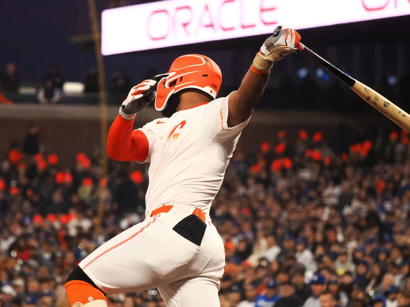 May 14, 2024; San Francisco, California, USA; San Francisco Giants left fielder Heliot Ramos (17) hits a RBI single against the Los Angeles Dodgers during the sixth inning at Oracle Park. Mandatory Credit: Kelley L Cox-USA TODAY Sports