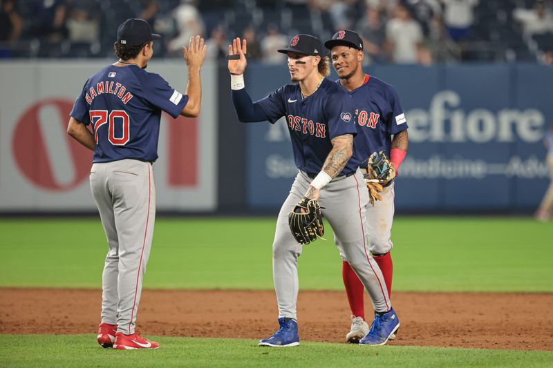 Jul 5, 2024; Bronx, New York, USA; Boston Red Sox center fielder Ceddanne Rafaela (43) and shortstop David Hamilton (70) and center fielder Jarren Duran (16) celebrates after defeating the New York Yankees at Yankee Stadium. Mandatory Credit: Vincent Carchietta-USA TODAY Sports