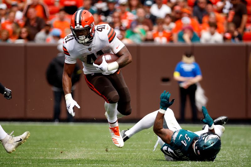 Cleveland Browns running back John Kelly Jr. (41) breaks a tackle by Philadelphia Eagles linebacker Shaun Bradley (54) during an NFL preseason football game, Sunday, Aug. 21, 2022, in Cleveland. (AP Photo/Kirk Irwin)