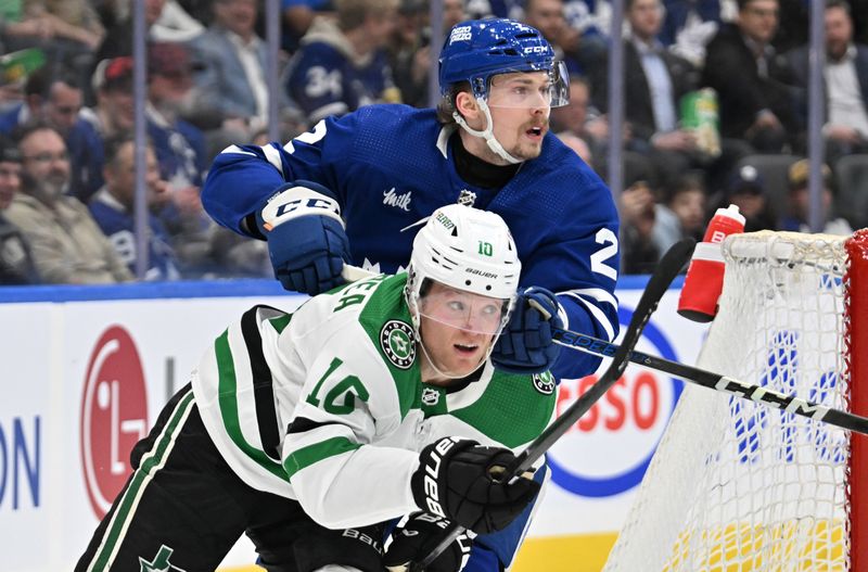 Feb 7, 2024; Toronto, Ontario, CAN; Toronto Maple Leafs defenseman Simon Benoit (2) covers Dallas Stars forward Ty Dellandrea (10) in the second period at Scotiabank Arena. Mandatory Credit: Dan Hamilton-USA TODAY Sports