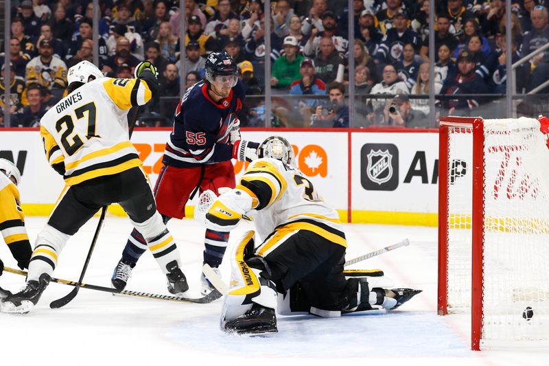 Oct 20, 2024; Winnipeg, Manitoba, CAN; Winnipeg Jets center Mark Scheifele (55) scores on Pittsburgh Penguins goaltender Alex Nedeljkovic (39) in the second period at Canada Life Centre. Mandatory Credit: James Carey Lauder-Imagn Images