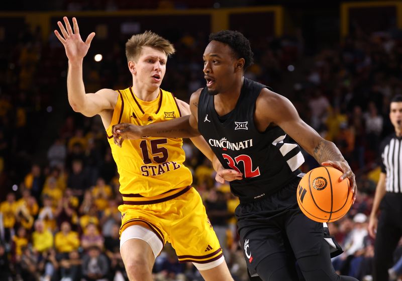 Jan 24, 2026; Tempe, Arizona, USA; Cincinnati Bearcats guard Jalen Celestine (32) moves the ball against Arizona State Sun Devils guard Noah Meeusen (15) in the first half at Desert Financial Arena. Mandatory Credit: Mark J. Rebilas-Imagn Images